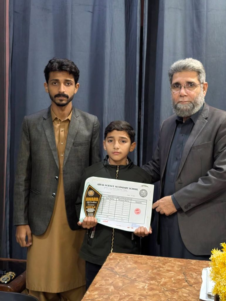 Student receiving Award of Excellence report card