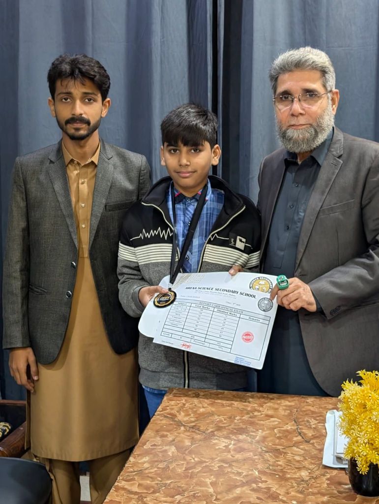 Student receiving report card and medal